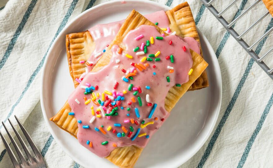 Breakfast pastries with pink icing and sprinkles